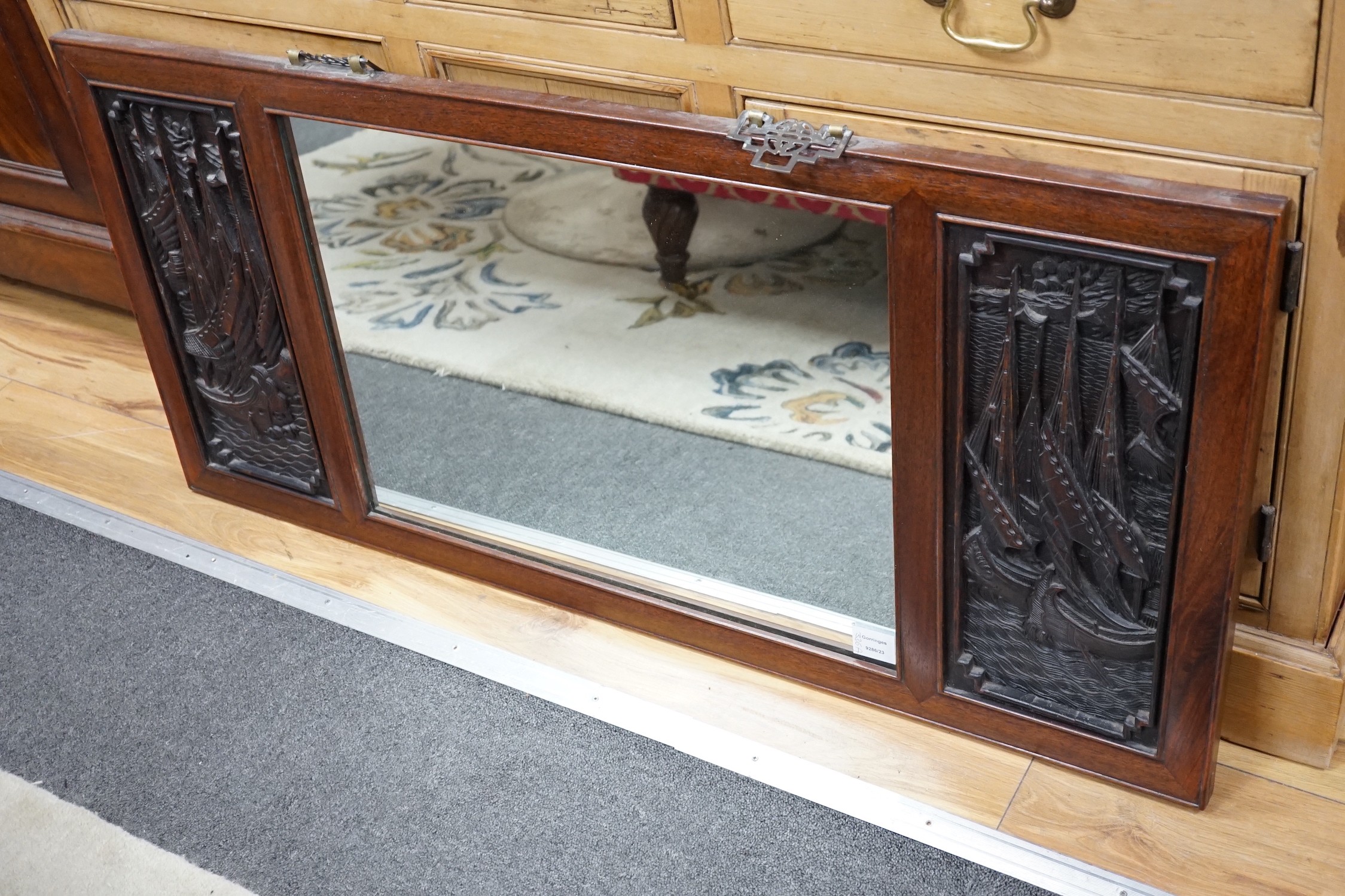 A Chinese hardwood relief carved wall mirror, width 114cm, height 53cm *Please note the sale commences at 9am.